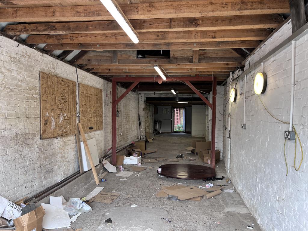 Lot: 180 - FREEHOLD GARAGE WORKSHOP - Inside view with concrete floor and brick walls